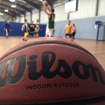 Wilson basketball with players on the background