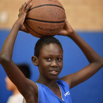 Kid with a basketball over his head