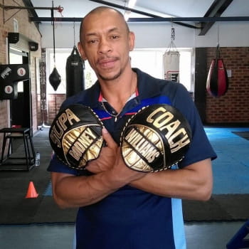 Boxing coach poses for a photo