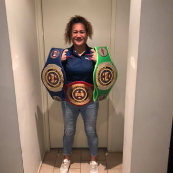 Boxing coach showing off her belts