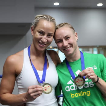 Boxing coaches showing off their medals