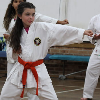young girl with red belt in karate