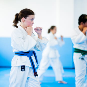 young girl with blue belt in karate