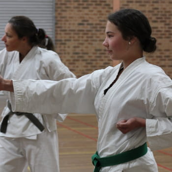 young girl with green belt in karate